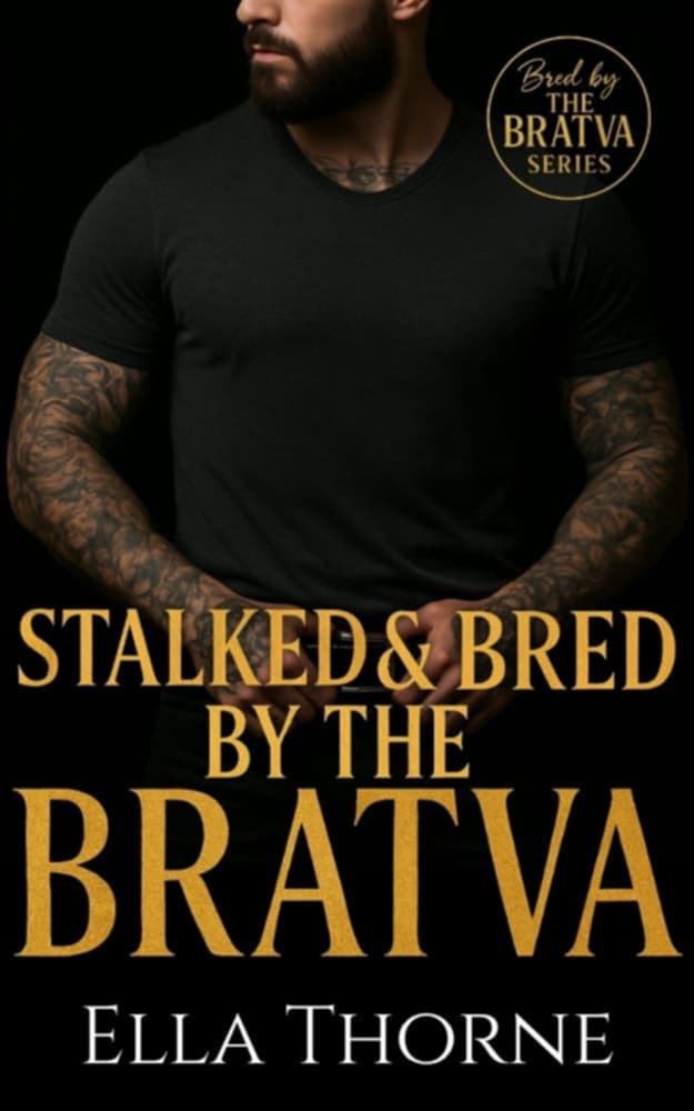 Man in leather jacket standing against a dark background. Tattoo's on his arms. Gold text reads Chased and BRed By The BRATVA
